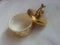 The decorative little golden pot with dolphin lid open, for room decoration