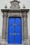 Decorative massive blue side door on late baroque Basilica of Our Lady of Seven Sorrows in Sastin Straze, western Slovakia