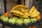 Decorative metallic tray filled with bananas, apples, kiwis and other juicy tropical fruits