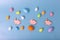 decorative multicolored eggs and pink gingerbread in the form of rabbit on blue background