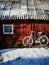 Decorative old painted in white bicycle near farm barn