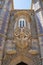 The decorative oriel window with the Triton sculpture over gateway of Creation. Sintra. Portugal