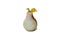 Decorative pear made of natural stone with a gilded twig on a white background close-up