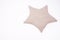 Decorative pillow star shaped made of rough natural organic cotton on a white background