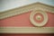 Decorative pink European style gable pattern with white stucco o