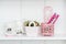 Decorative Pink Objects on White Shelf