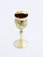 Decorative plastic glass made in the form of a gilded cup for the utterance of Jewish prayers isolated on a white background