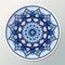 Decorative porcelain plate with mandala ornament in blue colors. Interior decoration.