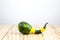 A decorative pumpkin Crookneck squash lying on wood