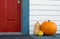 Decorative pumpkin and gourds on the front porch of a house