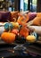 Decorative pumpkins of different sizes and shapes made of colored glass. Stylish Halloween decor. White blurred living