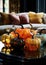 Decorative pumpkins of different sizes and shapes made of colored glass. Stylish Halloween decor. White blurred living