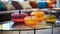 Decorative pumpkins of different sizes and shapes made of colored glass. Stylish Halloween decor. White blurred living