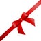 Decorative red bow with diagonally ribbon on the corner.