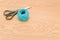 decorative rustic cyan yarn ball and scissors on a wooden tabletop