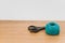 decorative rustic cyan yarn ball and scissors on a wooden tabletop