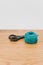 decorative rustic cyan yarn ball and scissors on a wooden tabletop