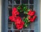 decorative seasonal wreath with red poinsettia flowers