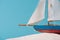 Decorative ship in white sand isolated on blue