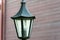 Decorative small garden lamp, Lanterns on a flower bed and in a green garden. Garden design. A small lantern gives coziness and