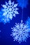 Decorative snowflakes on a blue background. Merry Christmas or