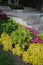 Decorative steps of stone with a nearby flower garden