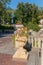 Decorative stone flowerbeds, decorated with sculptures of stucco on the background of the green park zone