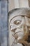 Decorative stone head carving on wall of Bodleian library courtyard, Oxford, United Kingdom