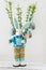 Decorative stuffed toy easter bunny with flower in hands and eggs