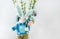 Decorative stuffed toy easter bunny with flower in hands and eggs