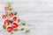 Decorative summer border of strawberry and mint leaf on white background with copy space, top view.