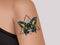 Decorative tattoo on female arm. Mystic butterfly tattoo. Realistic illustration