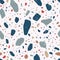 Decorative terrazzo texture. Seamless pattern with colorful mineral rock fragments scattered on white background. Modern