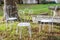 Decorative vintage metal white chairs furniture in a garden