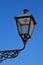 Decorative vintage street light in style of 19th century gas street lantern sunbathing in spring daylight sunshine