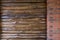 Decorative wall of pine boards painted with varnish. Wood texture. Brick column.