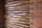 Decorative wall of pine boards painted with varnish. Wood texture. Brick column.