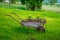 Decorative wheelbarrow-flower bed is installed on the lawn