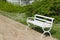 Decorative white bench in garden