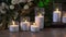 Decorative white bulk candles with wicks in transparent glass flasks.