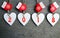 Decorative white wooden Christmas hearts and red mittens with 2018 numbers on wooden background with copy space.Happy New Year 201