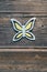 Decorative wooden butterfly on old farm wall