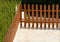 Decorative wooden fence for enclosing greenery.