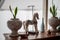Decorative wooden horse stands on the table near the window flowers in pots, white bottle, iron boat, elements of room decoration,