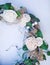 Decorative wreath decorated with artificial flowers, leaves, lace and mistletoe