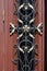 decorative wrought iron grille on the door. Detail of beautifully ornate wrought iron front door grill