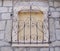 Decorative wrought iron grille on walled window