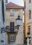 Decorative wrought iron street lamp on the wall of a brick house in the street of Split