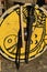 Decorative yellow medieval round shield with bird painting, one handed sword, light battle axe and machette