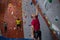 Dedicated athletes and trainer climbing wall in club